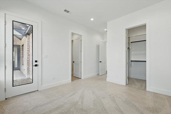 Unfurnished bedroom featuring visible vents, baseboards, recessed lighting, carpet floors, and a walk in closet | Image 29