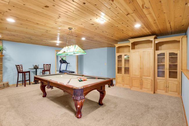 Challenge friends to a game of pool in the huge LL Game Room. The pool table is included in the sale of the home! | Image 23