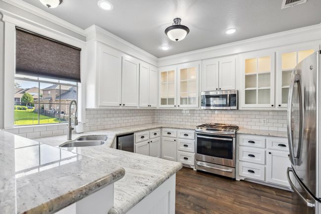 Upgraded counter tops with lots of serving space. Notice the updated appliances as well | Image 15