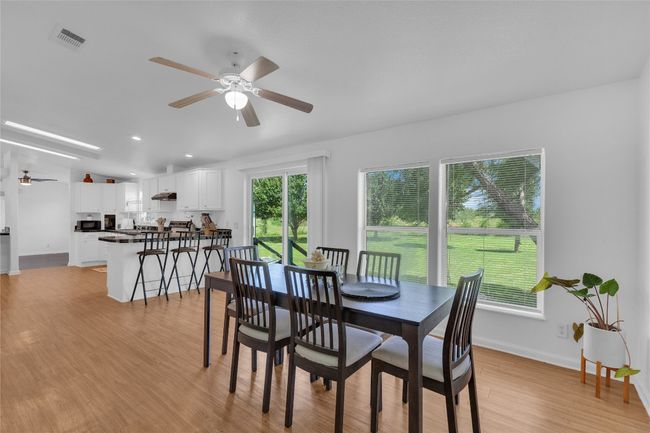 Dining room with a ceiling fan, light wood-type flooring, and recessed lighting | Image 14
