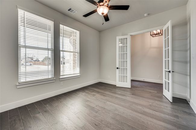 Spare room with french doors, wood finished floors, baseboards, and visible vents | Image 28