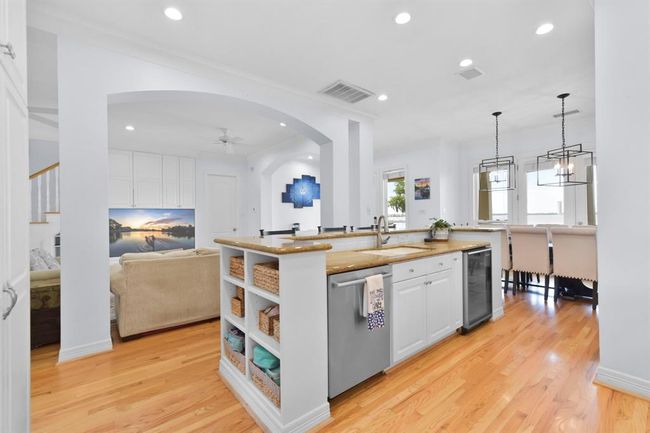 This stylish island features a convenient sink, dishwasher, and beverage cooler. | Image 20