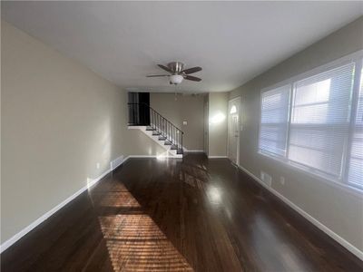 Unfurnished living room with ceiling fan and dark hardwood / wood-style floors | Image 3