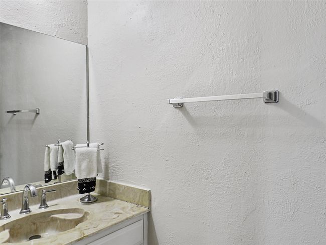 Bathroom with vanity and a textured wall | Image 21