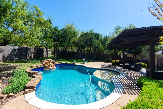 View of pool featuring a pergola, a patio, a fenced backyard, and a fenced in pool | Image 23