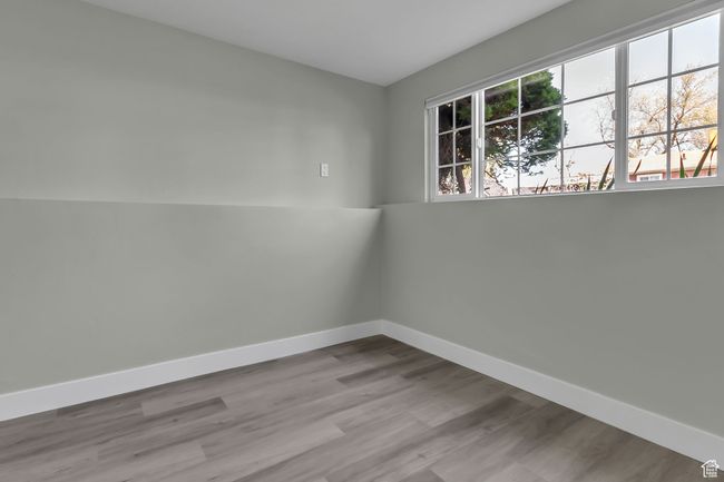 Spare room featuring wood finished floors and baseboards | Image 20