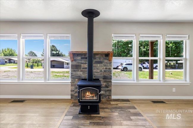 Detailed view of a wood stove and wood finished floors | Image 23