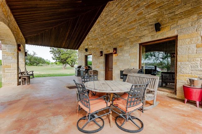 View of patio / terrace featuring grilling area and outdoor dining space | Image 7