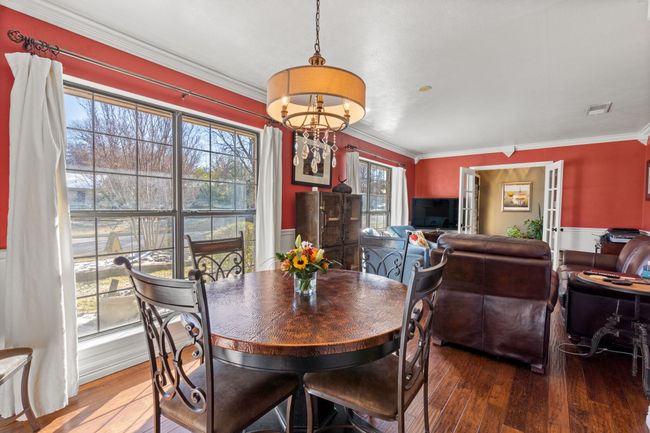 Dining space featuring hardwood / wood-style floors, a healthy amount of sunlight, and ornamental molding | Image 8