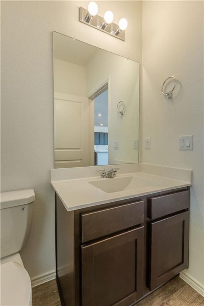 Half bathroom featuring vanity and wood finished floors | Image 21