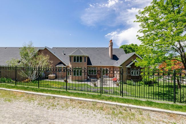 Back of house with a patio and a chimney | Image 94