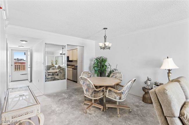 The living room is open and airy, perfect for entertaining or relaxing after a day at the beach. | Image 12