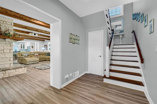 Stairway featuring wood finished floors, baseboards, and beamed ceiling | Image 7