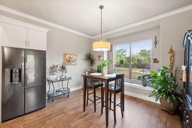 Breakfast area has window seat with view of pool and yard | Image 13