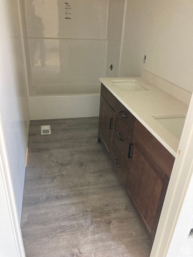 Full bathroom with double vanity and wood finished floors | Image 5
