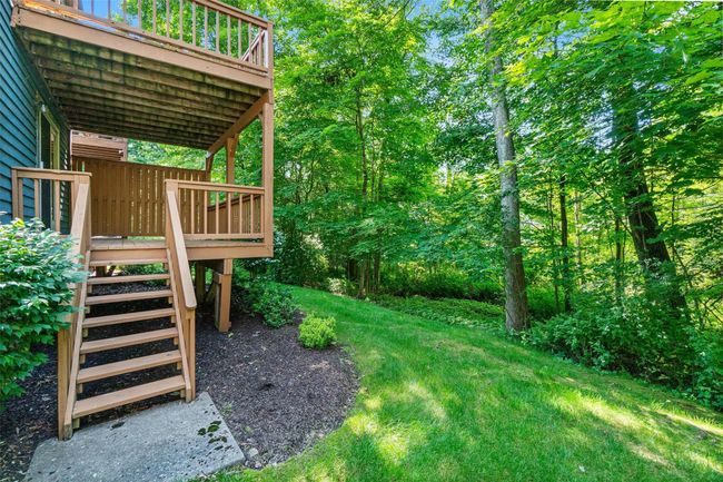 View of green lawn featuring a deck and stairway | Image 32