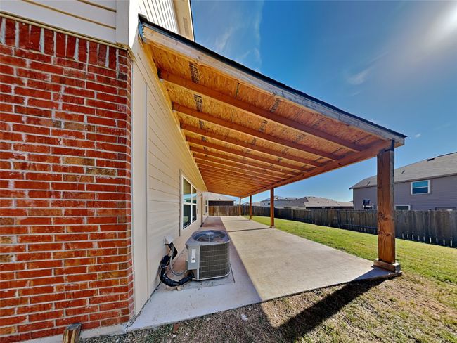 Fenced backyard with a patio area | Image 19