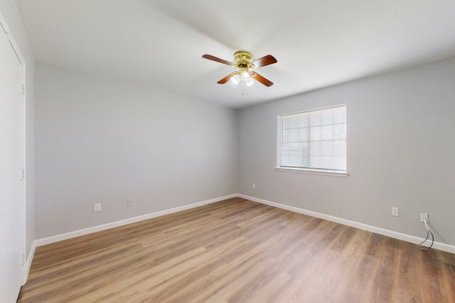 Unfurnished room featuring baseboards, light wood-type flooring, and a ceiling fan | Image 28