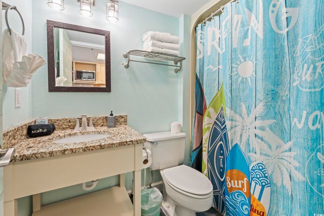 Bathroom featuring vanity and curtained shower | Image 7
