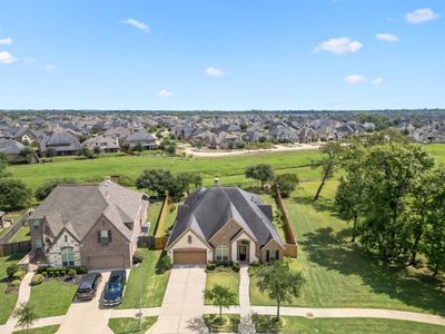 Stunning aerial view showcasing the oversized lot with NO back neighbors, community park located next to the home and luscious landscaping. | Image 3