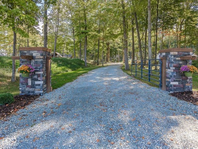view of dirt / gravel road featuring a gate and a gated entry | Image 49