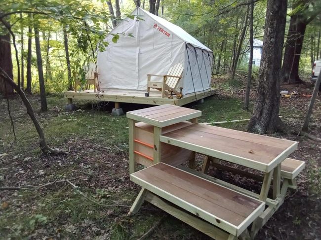 High-end glamping tent built on platform with custom picnic table | Image 4