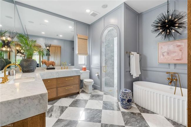 Full bath featuring a sink, double vanity, visible vents, a stall shower, and a notable chandelier | Image 23