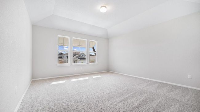 Carpeted spare room with lofted ceiling and baseboards | Image 24