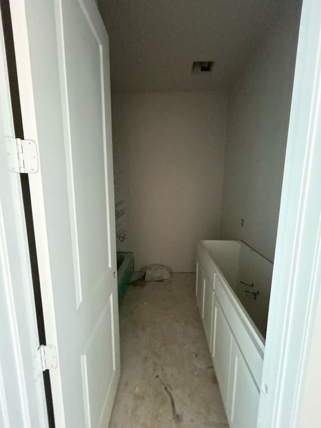 Full bathroom with concrete flooring and a bathtub | Image 8