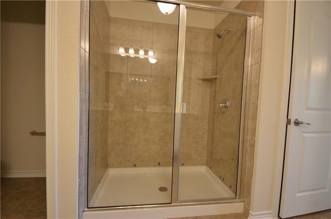 Bathroom featuring a shower stall and tile patterned floors | Image 19