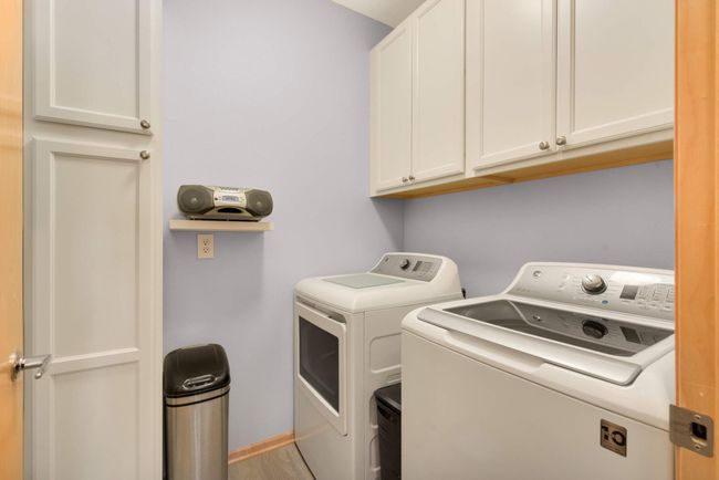 The in-unit laundry room is conveniently located near the closet and master bath, featuring GE washer/dryer and abundant storage. | Image 17