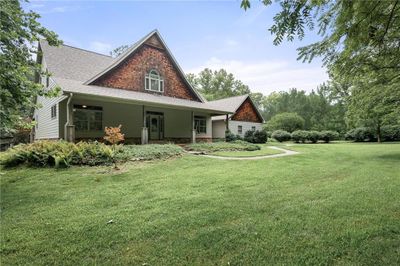 Rear view of house featuring a porch and a lawn | Image 3