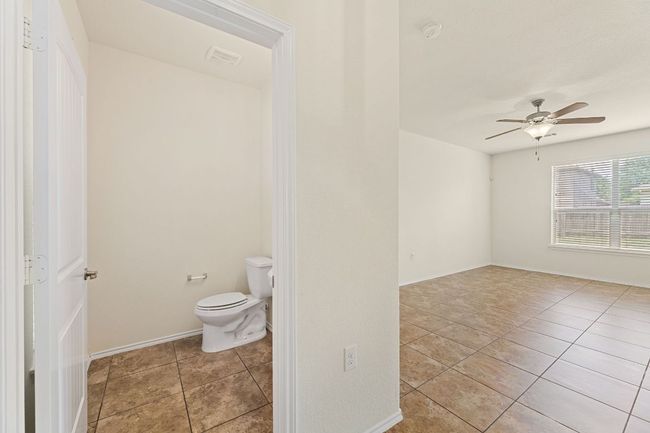 Bathroom featuring tile patterned floors and ceiling fan | Image 10