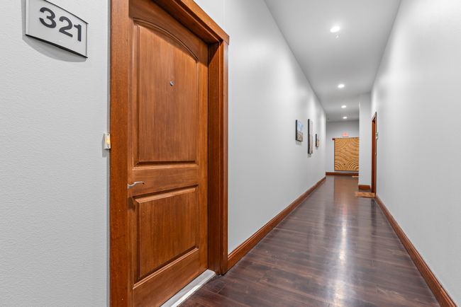 Hallway with recessed lighting, dark wood-style flooring, and baseboards | Image 18
