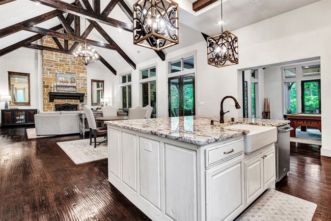 The kitchen is part of the large living area, and also blends seamlessly to the game room, which offers a professional wet bar and access to the media room. | Image 17