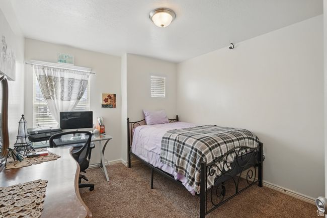Carpeted bedroom with baseboards and multiple windows | Image 30