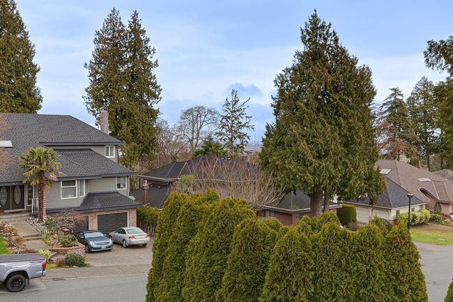 View of front facade with concrete driveway, roof with shingles, and an attached garage | Image 36