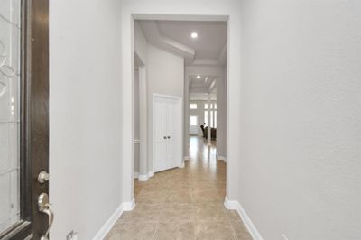 You are greeted by high ceilings upon entry! | Image 2