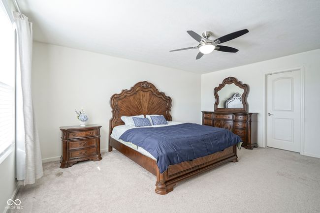 carpeted bedroom with baseboards and ceiling fan | Image 37