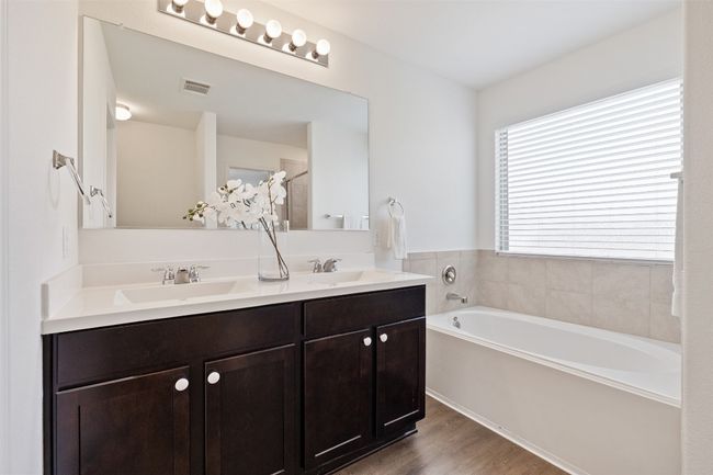 Full bath featuring a garden tub, double vanity, and wood finished floors | Image 22