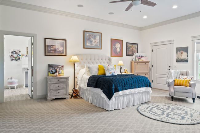 Bedroom with light carpet, baseboards, ceiling fan, ornamental molding, and recessed lighting | Image 17