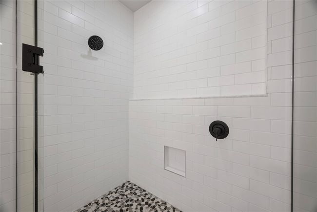 Tiled shower in primary bathroom, glass doors, private water closet | Image 22