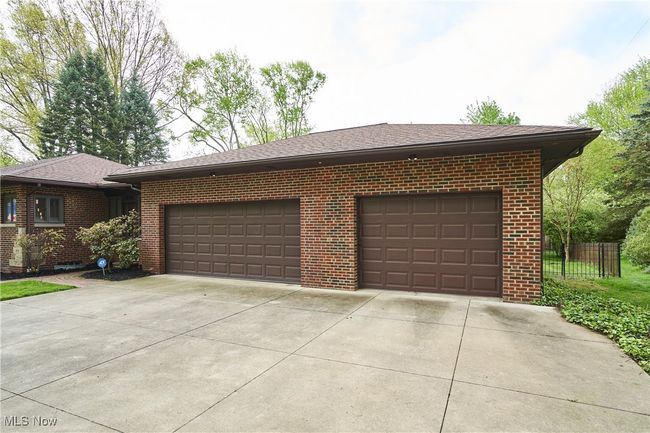 Garage with concrete driveway and fence | Image 27