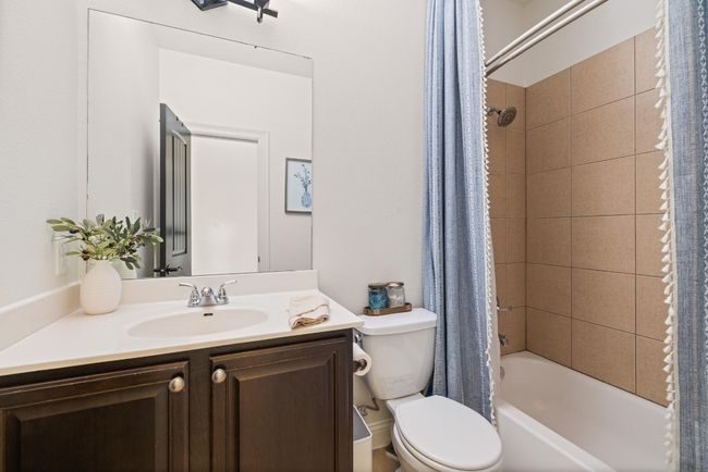 Bathroom featuring vanity, toilet, and shower / tub combo | Image 31