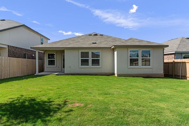 Back of property featuring a fenced backyard, roof with shingles, and stucco siding | Image 27