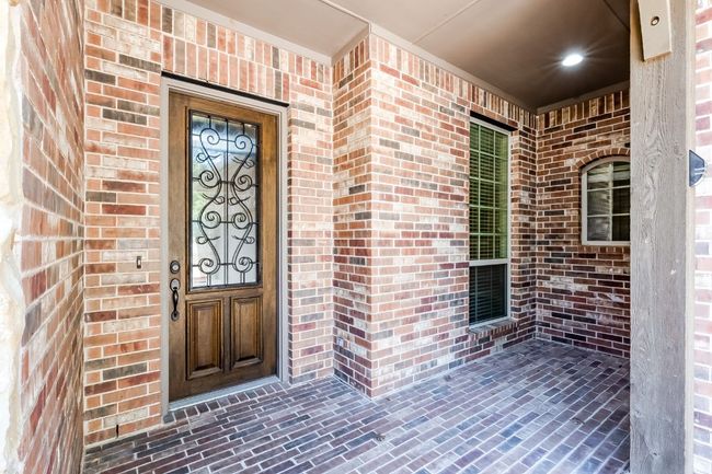 Doorway to property featuring brick siding | Image 4