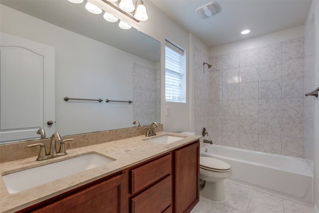 Full bath with a sink, visible vents, toilet, and shower / washtub combination | Image 22