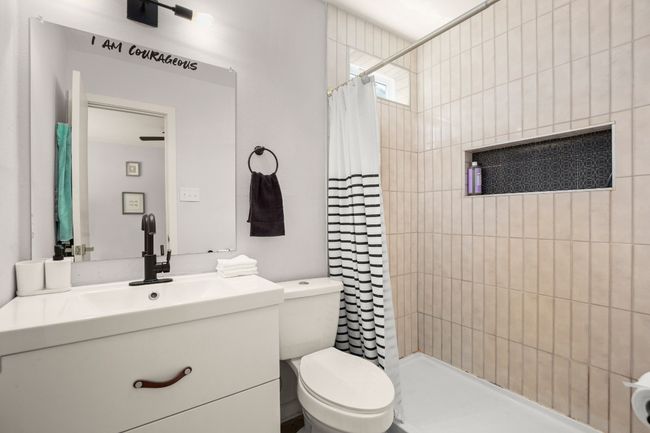 Bathroom with vanity, toilet, and tiled shower | Image 15