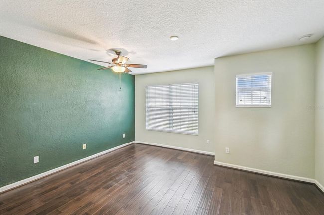 Upstairs primary bedroom features an en-suite, updated bathroom complete with a double vanity, garden tub, walk-in shower, and a private toilet closet. | Image 14
