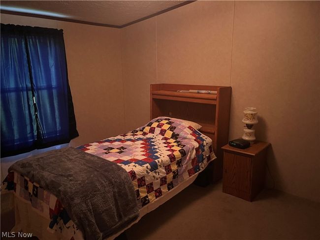 Carpeted bedroom featuring a textured ceiling | Image 12